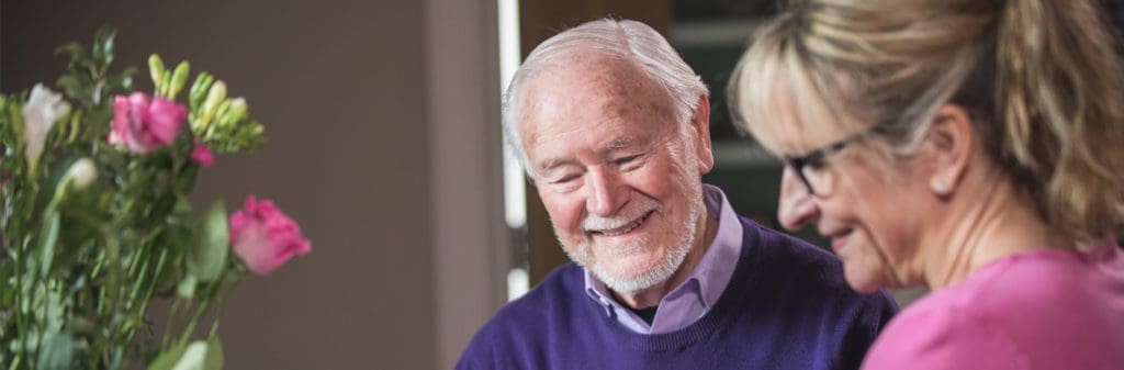 intermediate care_elderly man smiling with carer