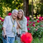 Client and carer taking a walk in the garden