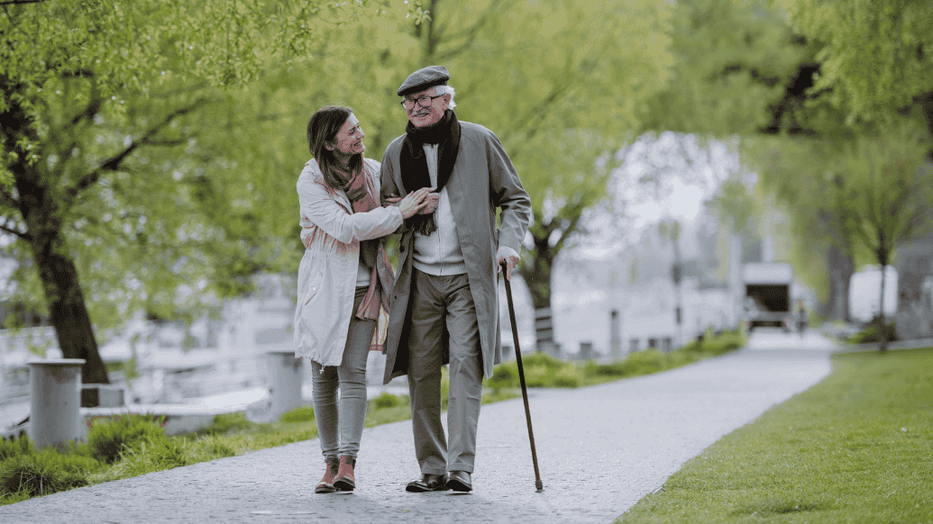 man and a carer walking